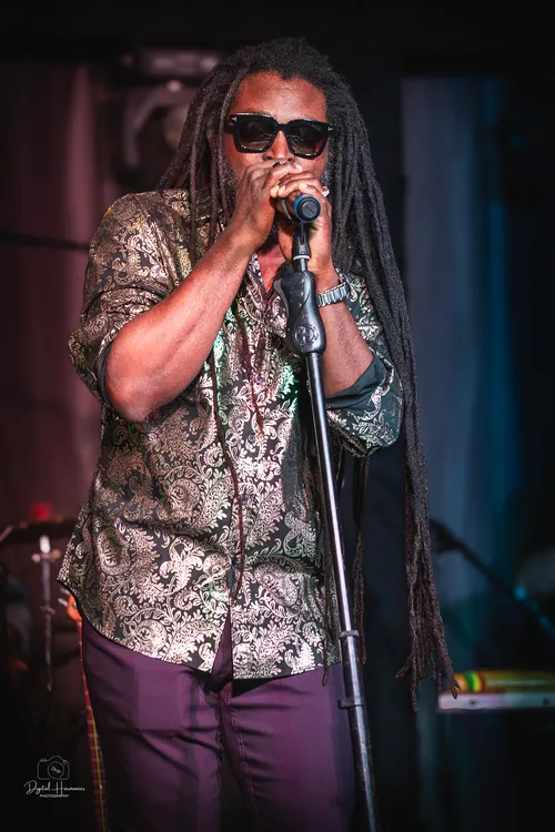 Jubba White singing into a microphone during a live performance